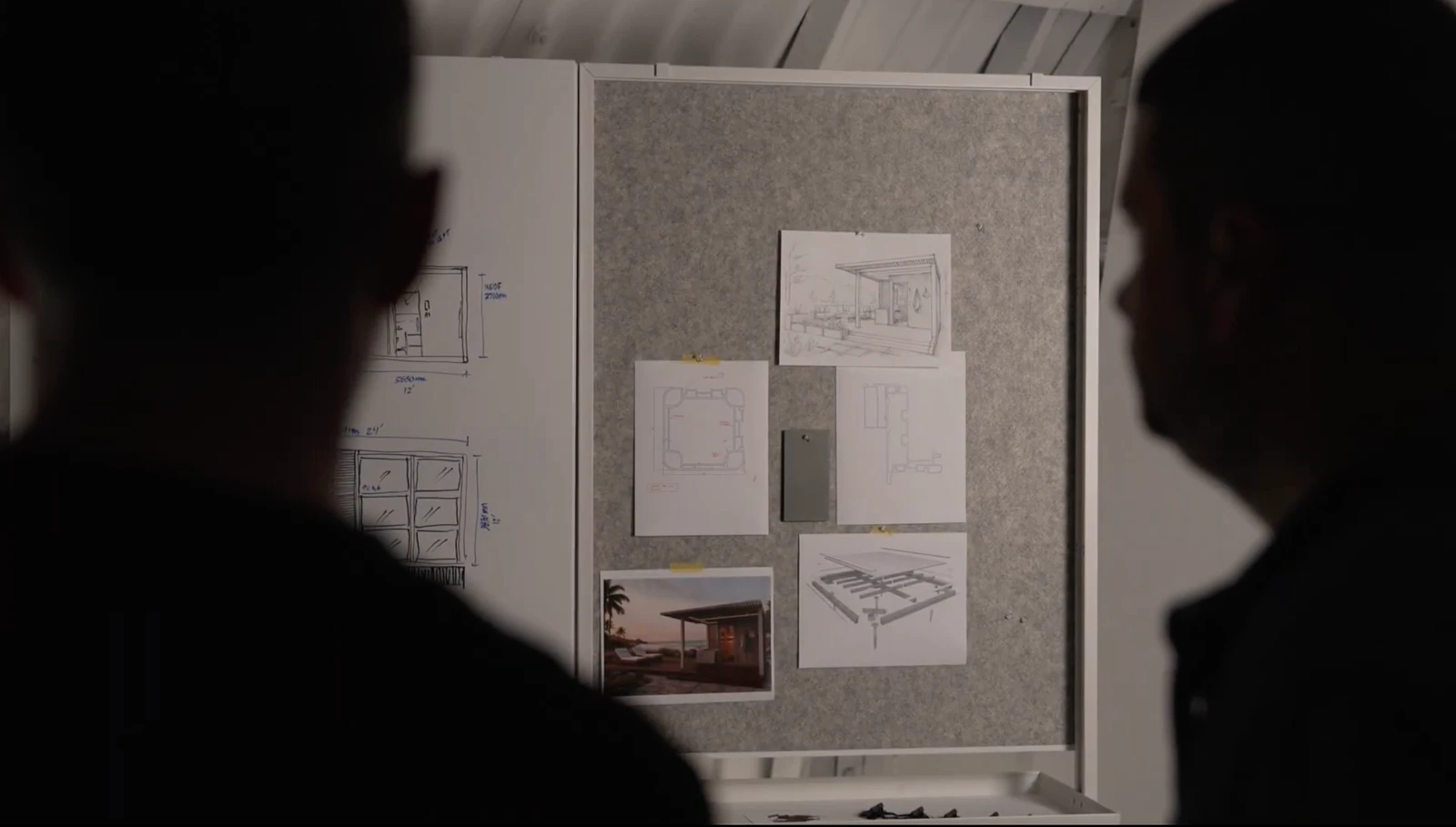 Designers reviewing pavilion drawings and material samples